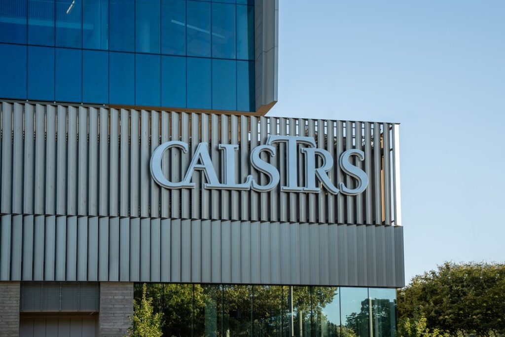Modern office building exterior with blue glass upper level and a metal louvered sign reading CALSIRS.