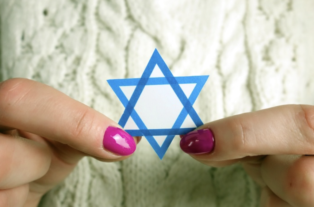 A girl's hands carefully holding a Star of David.