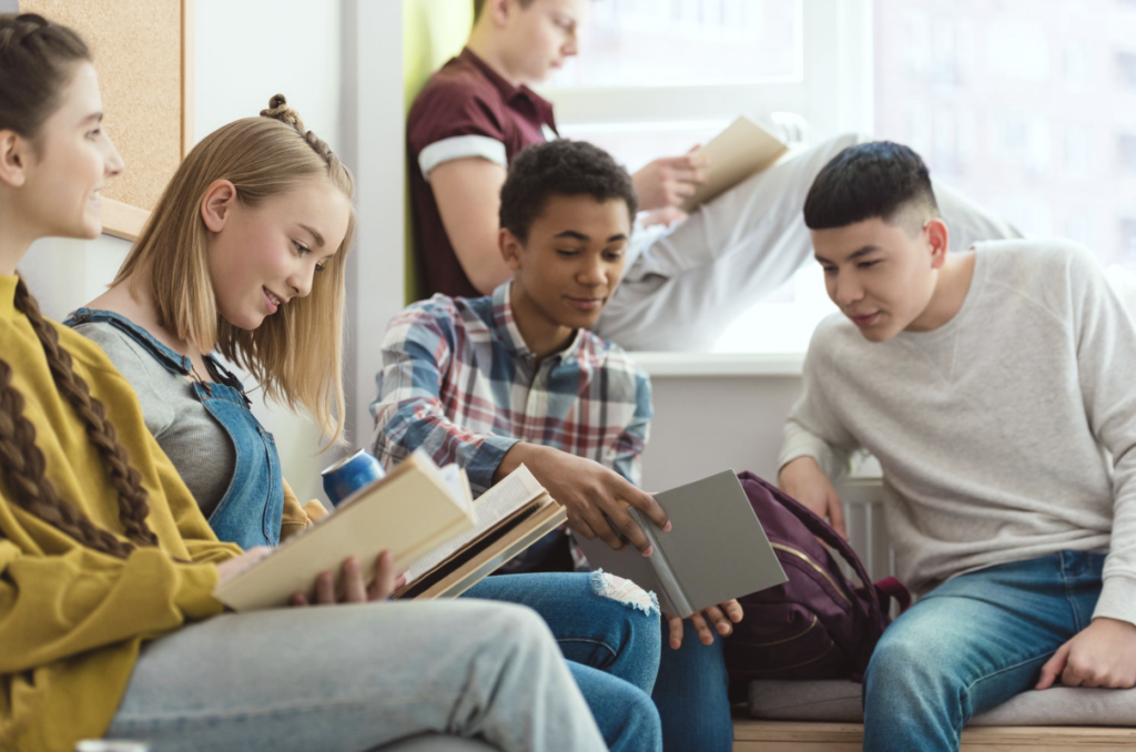 Image of high school students reading together in class.