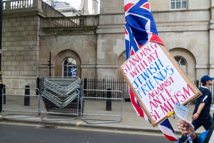 Protest sign for protecting Jewish community members from antisemitism.
