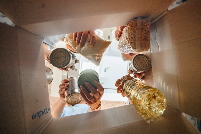 Volunteers putting donations in a box.