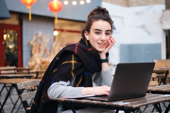 Teenage girl studying and doing research at her school’s cafe.